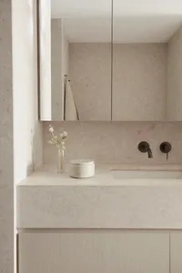 Modern bathroom with concrete tile walls, a sleek floating vanity, and minimalist design.