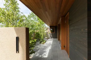 A modern exterior architectural design featuring wooden boards.