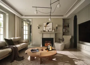 Modern living room featuring a neutral color palette, comfortable seating, a fireplace, and a round coffee table.