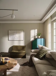 A modern living room featuring a comfortable sofa with a square patterned cushion and an upholstered armchair in a cozy setti