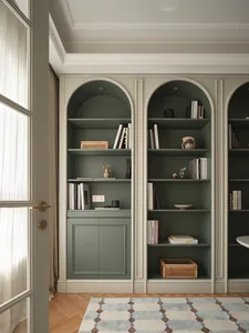Modern minimalist home library featuring green paneled walls and wooden cabinetry, with books and decorative items on shelves