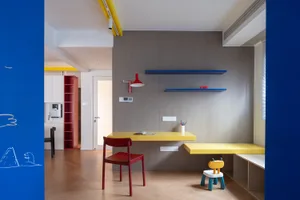 A modern home office space featuring yellow and gray color theme with functional storage and work areas.