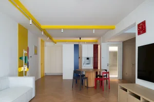 A modern open-plan living space featuring wood flooring and minimalistic design elements.