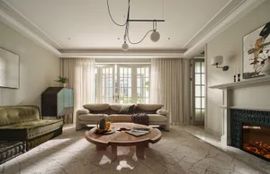 A modern residential living room with neutral-toned walls, curtains, and furniture, featuring a round wooden coffee table, a 