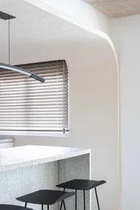 A minimalist interior design featuring polished concrete walls and a clean, modern aesthetic.