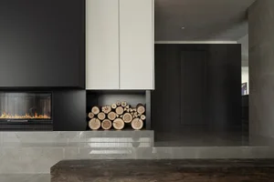 Modern minimalist living room with a fireplace and concrete floor and walls