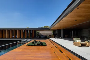 A modern residential area featuring a wooden walkway and a swimming pool.