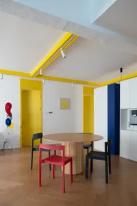 A minimalist residential interior featuring a wooden floor, metal furniture, and acrylic walls.