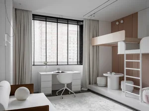 A modern home office space featuring a minimalist design with neutral colors, a desk, and a comfortable seating area with a b