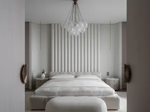 A modern minimalist bedroom with a white bed and ottoman, mounted pendant lights, and minimalist decorations.