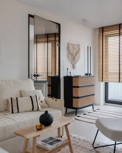 A minimalist living room featuring neutral-toned furniture and decor.