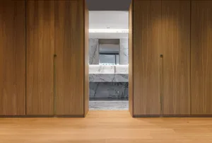 Modern bathroom with marble walls and floor, featuring minimalist design.