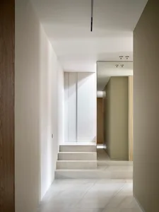 Modern interior design featuring marble hallway with stairs.
