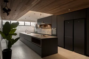 A modern residential kitchen with concrete countertops and minimalist design.
