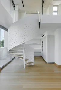 A modern white perforated metal staircase interior design