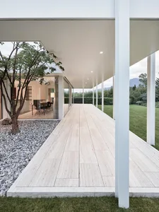A modern exterior featuring a glass-enclosed jacuzzi.