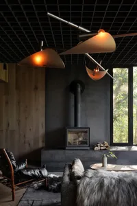 Industrial-style living room featuring concrete surfaces, minimalistic design, and a cozy fireplace.