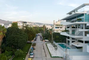 A modern residential building with concrete and glass exterior materials.