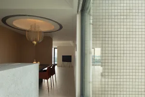 Modern kitchen featuring white tile walls and wooden flooring with metal accents