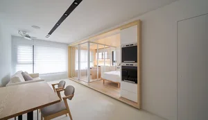 A minimalist living room with white walls and furniture.