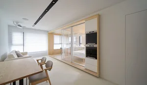 White minimalist residential interior with glass and wooden furniture.