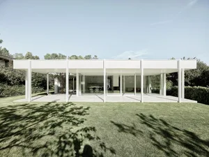 A modern residential building with white exterior, large glass windows, and a minimalist design.