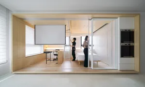 An example of a minimalist living space featuring wood materials.
