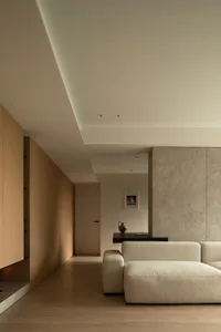 A modern living room featuring a combination of wooden and concrete materials.