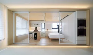 A minimalist residential space featuring light-colored wood flooring and white walls.