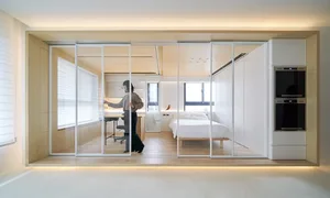 Modern bedroom with transparent glass walls and white furnishings