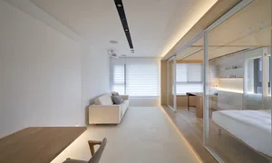 A modern, white residential interior with wooden furniture and a minimalistic design.