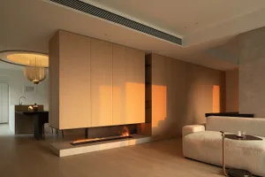 Modern living room with wooden paneling and a cozy fireplace