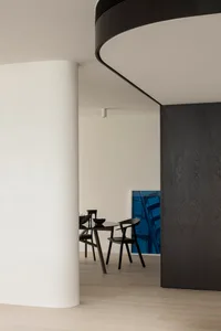 Modern minimalist dining room featuring black wood furniture and sleek design