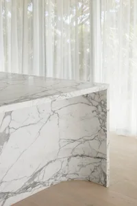 A minimalist interior design featuring a marble table.