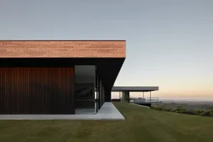 Modern house with wooden exterior and large glass windows