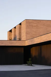 A modern building with a brick exterior under a clear sky.