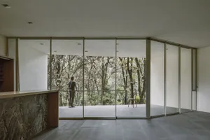 A modern interior space featuring a glass ceiling allowing natural light to flood the room.