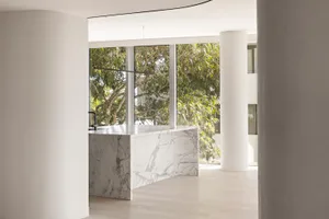 Modern residential kitchen featuring marble countertops and floors.