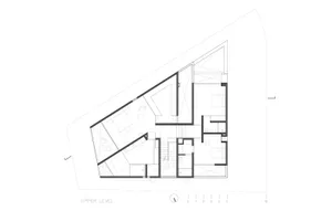 Floor plan of a modern upper level with furnished rooms and architectural details.