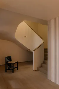 A modern staircase interior featuring wooden paneling.