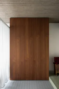 Modern cabinetry with sleek wooden surfaces in a minimalist interior setting.