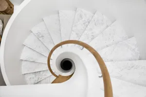 A spiral staircase made of white marble.
