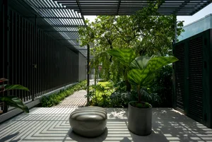 A modern interior space featuring concrete flooring and various green plants.