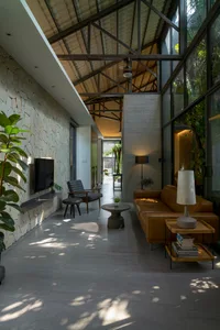 A modern living room featuring concrete, wood, and glass materials.