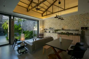 A modern living room with a stone accent wall and open concept design.