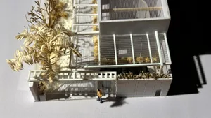 A detailed architectural model featuring a modern interior decoration with white elements and a minimalist design.