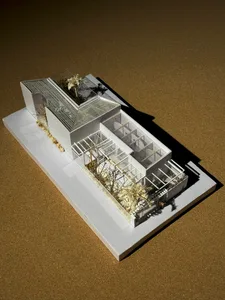 Modern residential greenhouse with glass walls and concrete base