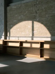 Industrial-style interior with wooden shelves and a brick wall