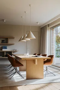 Modern interior design featuring a wooden dining table and chairs