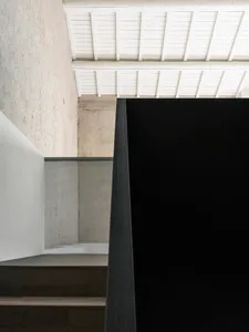 Modern interior design showcasing sleek black steel framed windows and minimalist decor.